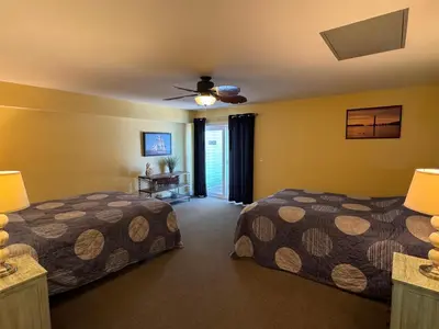 a bedroom with two beds and a ceiling fan at Put-in-Bay Waterfront Condo #209 in Put-in-Bay