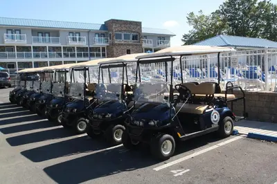 a row of golf carts parked in a parking lot at Put-in-Bay Waterfront Condo #209 in Put-in-Bay