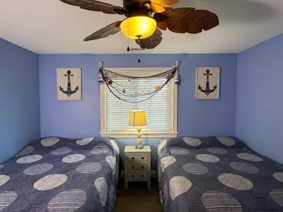a bedroom with two beds and a ceiling fan at Put-in-Bay Waterfront Condo #209 in Put-in-Bay