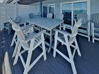 a wooden table and chairs on a deck at Put-in-Bay Waterfront Condo #206 in Put-in-Bay