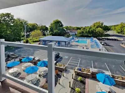 a view from a balcony of a pool with umbrellas at Put-in-Bay Waterfront Condo #206 in Put-in-Bay
