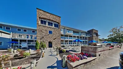a building with flowers in front of it at Put-in-Bay Waterfront Condo #206 in Put-in-Bay