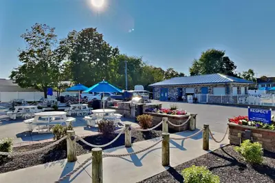 a patio with tables and umbrellas in a parking lot at Put-in-Bay Waterfront Condo #206 in Put-in-Bay