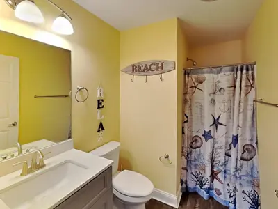 a bathroom with a toilet sink and a shower curtain at Put-in-Bay Waterfront Condo #206 in Put-in-Bay