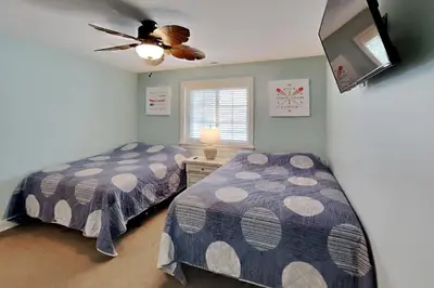 a bedroom with two beds and a ceiling fan at Put-in-Bay Waterfront Condo #207 in Put-in-Bay