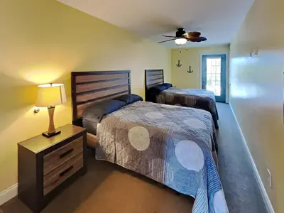 a bedroom with two beds and a ceiling fan at Put-in-Bay Waterfront Condo #208 in Put-in-Bay