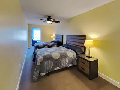 a bedroom with two beds and a ceiling fan at Put-in-Bay Waterfront Condo #208 in Put-in-Bay