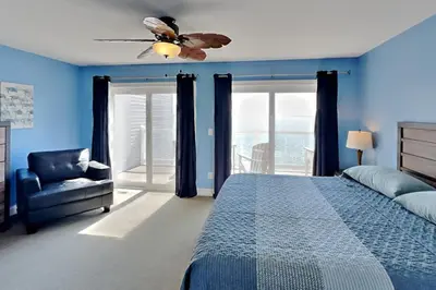 a bedroom with a bed and a ceiling fan at Put-in-Bay Waterfront Condo #208 in Put-in-Bay