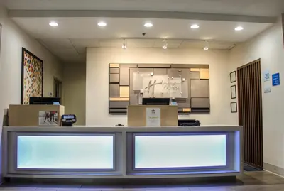 a store front counter with two white signs on the wall at Holiday Inn Express Hotel & Suites Athens by IHG in Athens