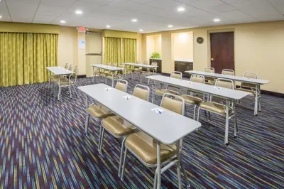 a conference room with tables and chairs in it at Holiday Inn Express Hotel & Suites Ashland by IHG in Ashland