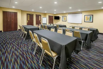 a conference room with tables and chairs and a whiteboard at Holiday Inn Express Hotel & Suites Ashland by IHG in Ashland