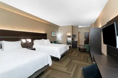 a hotel room with two beds and a flat screen tv at Holiday Inn Express Hotel & Suites Ashland by IHG in Ashland