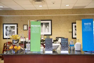 a counter with signs on it in a restaurant at Hampton Inn Morehead in Morehead