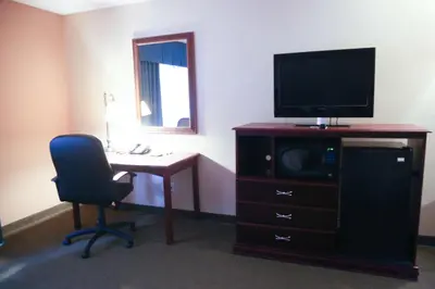 a room with a desk and a television and a chair at Hampton Inn Morehead in Morehead