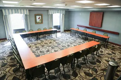 a room with rows of tables and chairs in it at Hampton Inn Morehead in Morehead