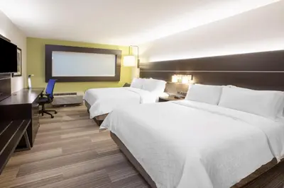 a hotel room with two beds and a flat screen tv at Holiday Inn Express Hocking Hills-Logan by IHG in Logan