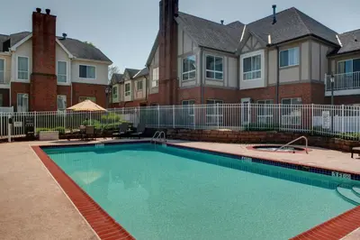 a swimming pool in front of a house at Residence Inn by Marriott Cleveland Independence in Independence