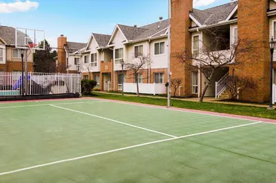 a tennis court in front of some houses at Residence Inn by Marriott Cleveland Independence in Independence