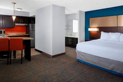 a hotel room with a bed and a kitchen at Residence Inn by Marriott Cleveland Independence in Independence