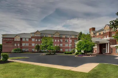 a large red brick building with a parking lot at Residence Inn by Marriott Cleveland Beachwood in Beachwood
