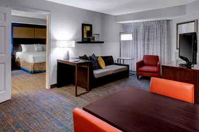 a hotel room with a bed and a living room at Residence Inn by Marriott Cleveland Beachwood in Beachwood