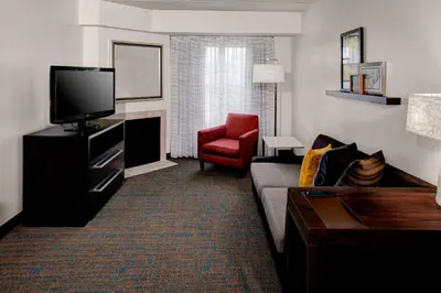 a living room with a couch and a television at Residence Inn by Marriott Cleveland Beachwood in Beachwood