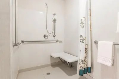 a white bathroom with a shower and a toilet at Residence Inn by Marriott Cleveland Mentor in Mentor