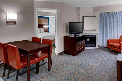 a hotel room with a table and a television and a bed at Residence Inn by Marriott Cleveland Mentor in Mentor