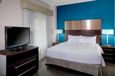 a hotel room with a bed and a flat screen tv at Residence Inn by Marriott Cleveland Downtown in Cleveland