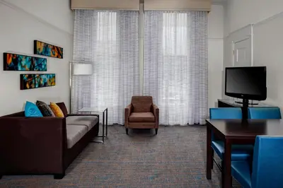a living room with a couch and a tv and a chair at Residence Inn by Marriott Cleveland Downtown in Cleveland