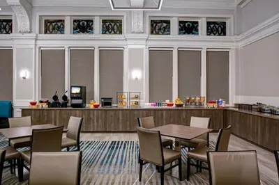 a restaurant with tables and chairs and a counter at Residence Inn by Marriott Cleveland Downtown in Cleveland