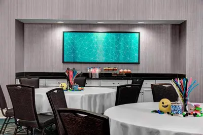 a conference room with two tables and a projection screen at Residence Inn by Marriott Cleveland Downtown in Cleveland