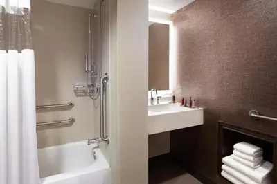 a bathroom with a sink and a tub and a toilet at Cincinnati Marriott at RiverCenter in Covington