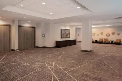 a large room with a waiting area in a building at Cincinnati Marriott at RiverCenter in Covington
