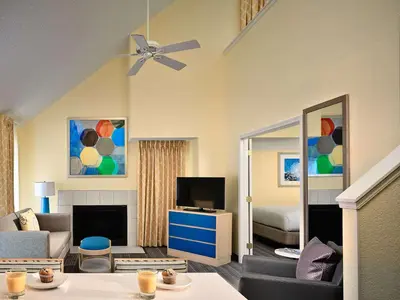 a living room with a couch and a tv at Sonesta Simply Suites Cleveland Westlake in Westlake