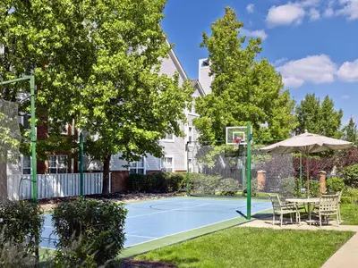 a tennis court with a basketball hoop and an umbrella at Sonesta Simply Suites Cleveland Westlake in Westlake