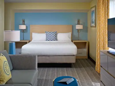 a bedroom with a bed and a couch and a chair at Sonesta Simply Suites Cleveland Westlake in Westlake