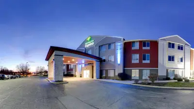 a hotel building with a parking lot in front of it at Holiday Inn Express Fort Wayne - East - New Haven by IHG in New Haven