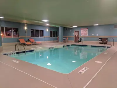 a large swimming pool with blue water in a building at Holiday Inn Express Fort Wayne - East - New Haven by IHG in New Haven