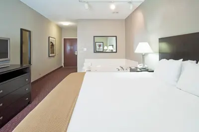 a large bedroom with a large bed and a television at Holiday Inn Express Fort Wayne - East - New Haven by IHG in New Haven
