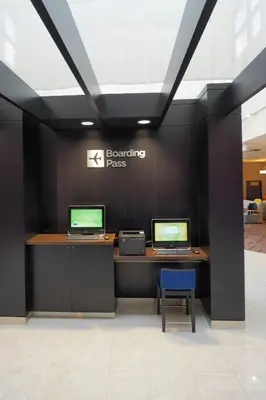two computers on a desk with a sign on a wall at Courtyard by Marriott Columbus West/Hilliard in Columbus