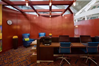 an office with a table and chairs and a clock at Courtyard by Marriott Columbus West/Hilliard in Columbus