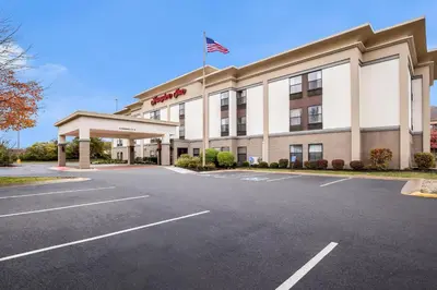 a hotel with an american flag in a parking lot at Hampton Inn Akron-Fairlawn in Montrose