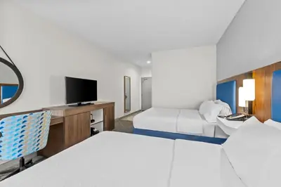 a hotel room with two beds and a tv at Hampton Inn Akron-Fairlawn in Montrose