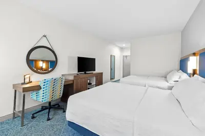 a hotel room with two beds and a desk with a mirror at Hampton Inn Akron-Fairlawn in Montrose