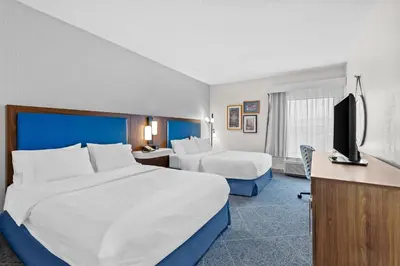 a hotel room with two beds and a flat screen tv at Hampton Inn Akron-Fairlawn in Montrose