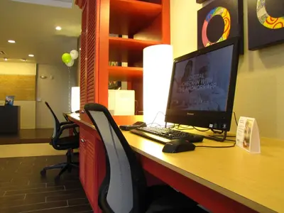 a desk with a computer monitor and a keyboard and mouse at Home2 Suites By Hilton-Cleveland Beachwood in Beachwood