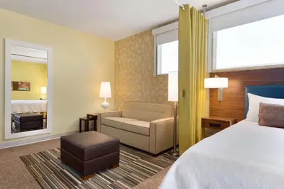 a hotel room with a bed and a chair at Home2 Suites By Hilton-Cleveland Beachwood in Beachwood