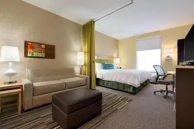 a hotel room with a bed and a couch at Home2 Suites by Hilton Cincinnati Liberty Township in Wetherington