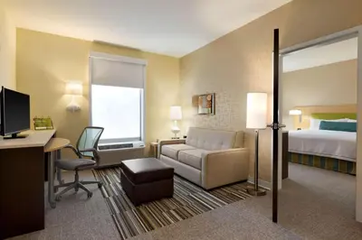 a hotel room with a bed and a desk at Home2 Suites by Hilton Cincinnati Liberty Township in Wetherington